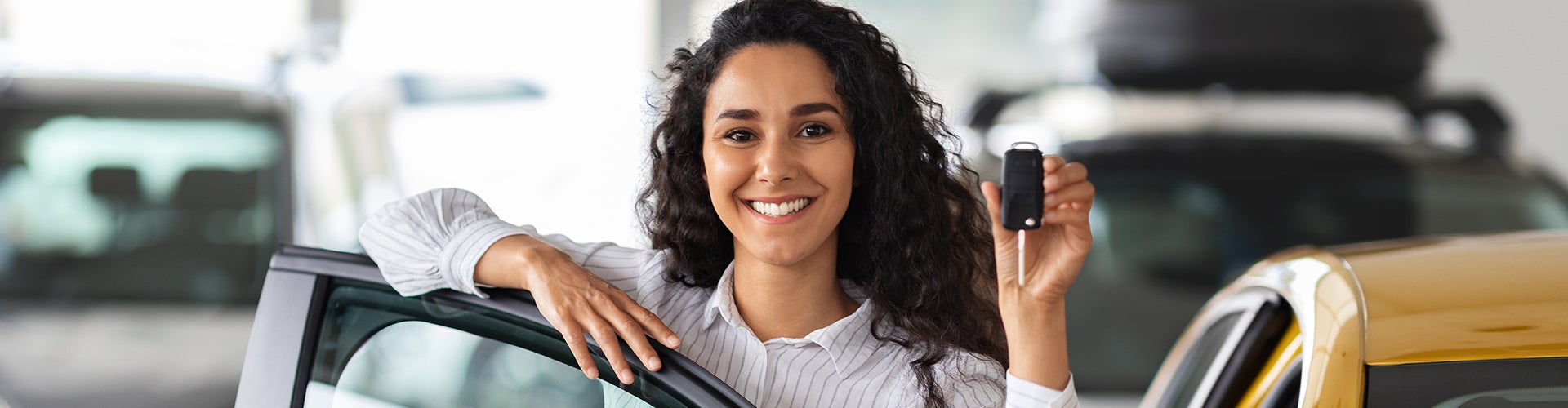 First time buyer showing her new car keys