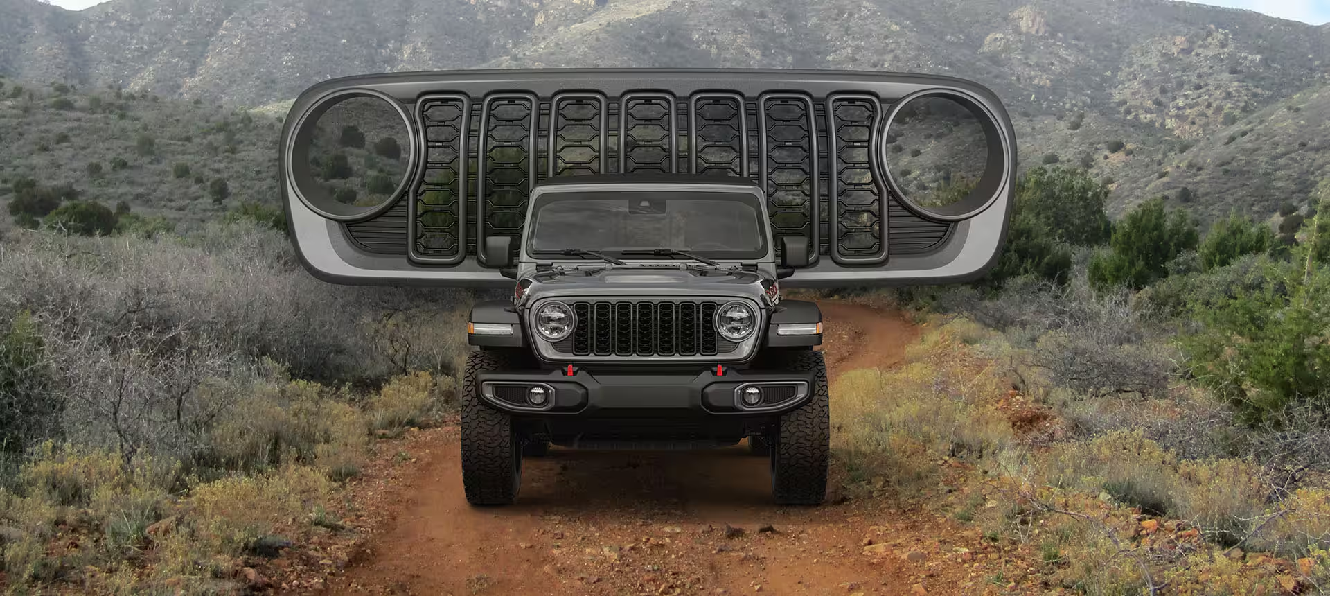 Front end of a 2024 Jeep Wrangler on a trail 