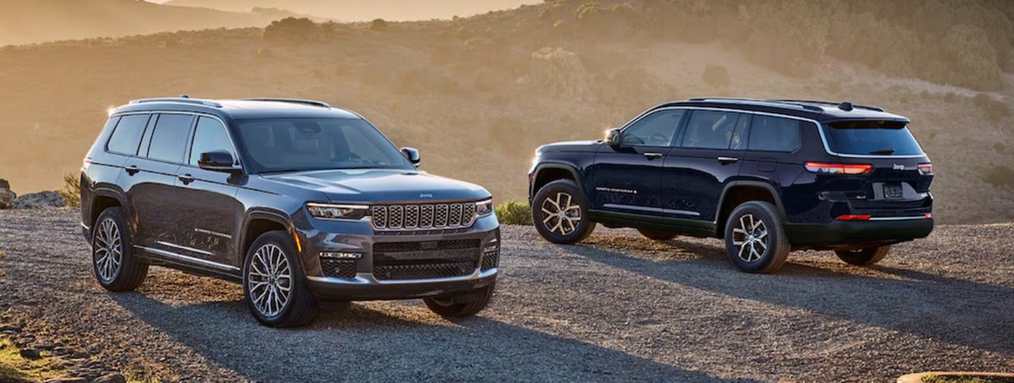 A gray Jeep Grand Cherokee and a black Jeep Grand Cherokee parked in opposite directions